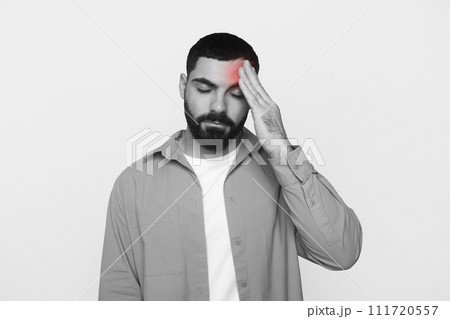 Unhappy young latin man with beard in casual put hand on forehead Unhappy young latin man with beard in casual put hand on forehead 111720557