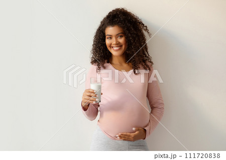 Pregnancy Nutrition. Portrait Of Black Smiling Pregnant Woman With Glass Of Milk Pregnancy Nutrition. Portrait Of Black Smiling Pregnant Woman With Glass Of Milk 111720838