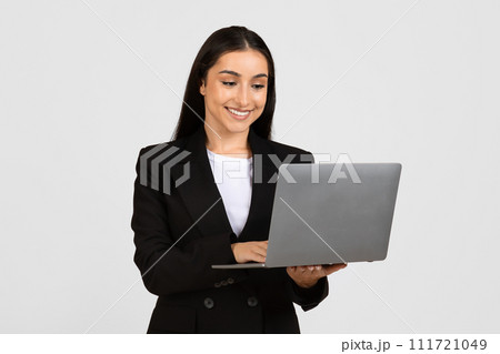 Happy young businesswoman using laptop computer Happy young businesswoman using laptop computer 111721049