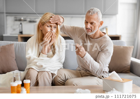 Senior man treating his sick wife at home Senior man treating his sick wife at home 111721075