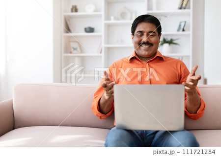 Positive middle aged eastern man have video call on laptop 111721284