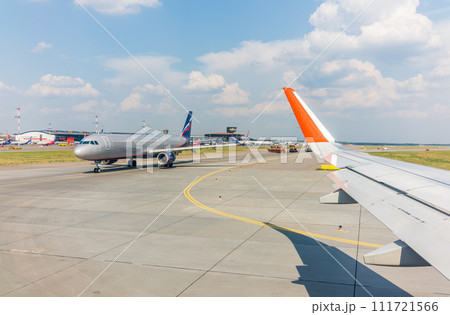 View from the airplane window during takeoff at Sheremetyevo airport at summer View from the airplane window during takeoff at Sheremetyevo airport at summer 111721566