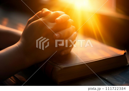 hands are folded in prayer on a Holy Bible .Holy Bible study reading together in Sunday . Generative AI 111722384