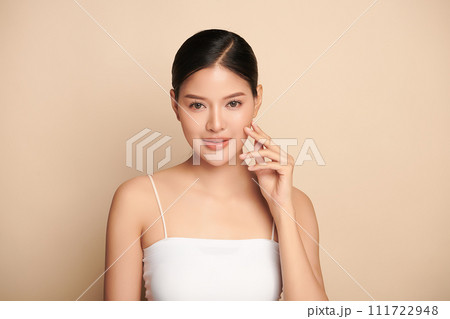 Beautiful young asian woman with clean fresh skin on beige background, Face care, Facial treatment, Cosmetology, beauty and spa, Asian women portrait. 111722948