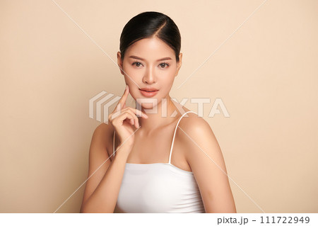 Beautiful young asian woman with clean fresh skin on beige background, Face care, Facial treatment, Cosmetology, beauty and spa, Asian women portrait. 111722949