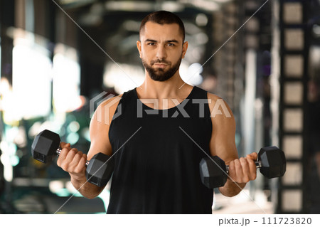 Gym Workout. Young Muscular Man Training With Dumbbells In Sport Club 111723820