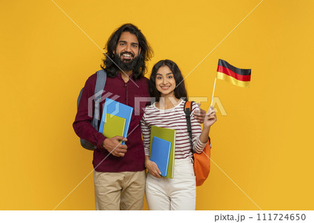 Smiling indian man and woman students showing flag of Germany 111724650