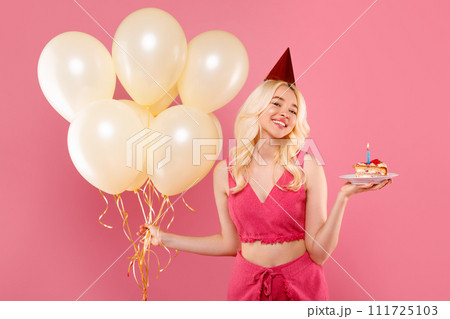 Joyful young blonde lady with balloons and birthday cake, party mood 111725103