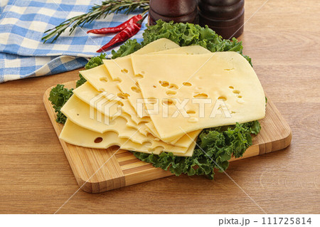Sliced maasdam cheese for breakfast 111725814