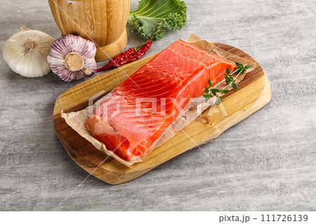 Raw salmon fillet over board Raw salmon fillet over board 111726139