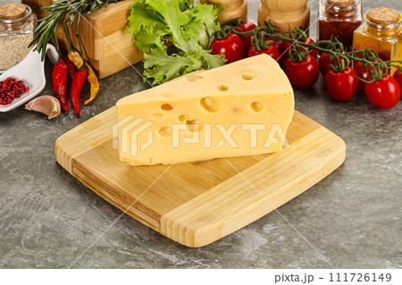 Swiss Maasdam cheese triangle over board 111726149