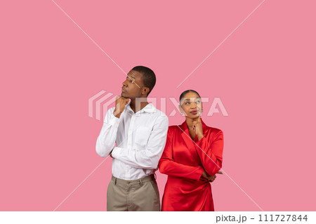Thoughtful black couple in white and red with curious poses 111727844