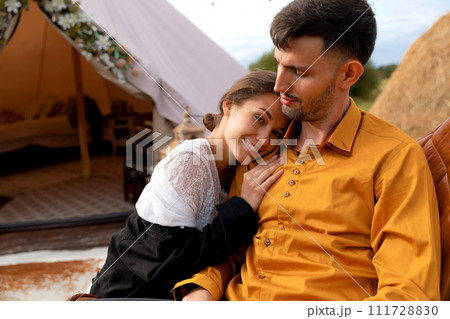 Intimate wedding at the nature romantic couple next to the glamping tent Intimate wedding at the nature romantic couple next to the glamping tent 111728830