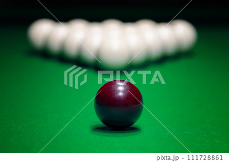 Ball is displayed on the pool table against the background of other balls 111728861