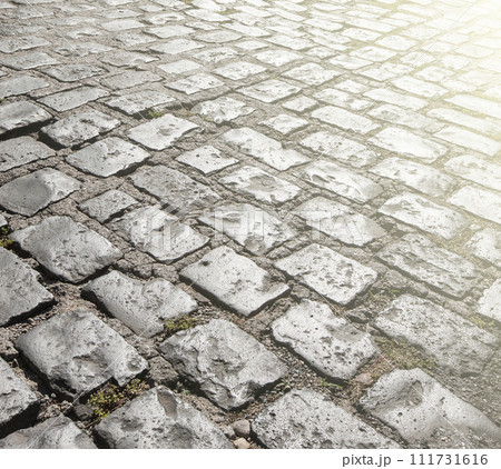 Old stone pavement texture on soft sunlight 111731616