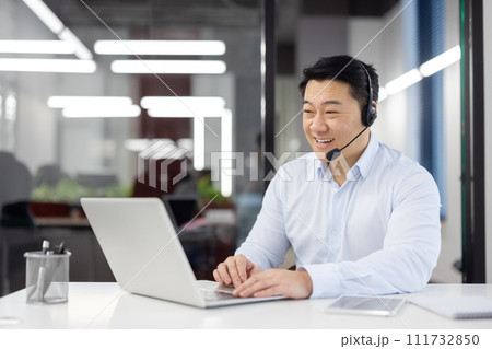 Man with headset phone close-up at workplace inside office, Asian in shirt customer service worker, businessman using laptop for video call, and customer consultation, telephone sales, Man with headset phone close-up at workplace inside office, Asian in shirt customer service worker, businessman using laptop for video call, and customer consultation, telephone sales, 111732850