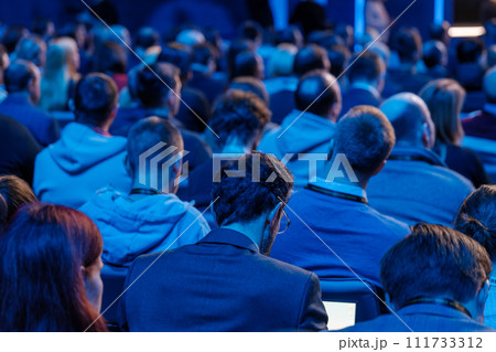 Audience at professional conference listening to speaker presentation Audience at professional conference listening to speaker presentation 111733312