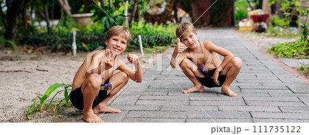 Boy blond freckles squatting sit smiling show gesture thumbs up shirtless bare chested shorts nature Boy blond freckles squatting sit smiling show gesture thumbs up shirtless bare chested shorts nature 111735122