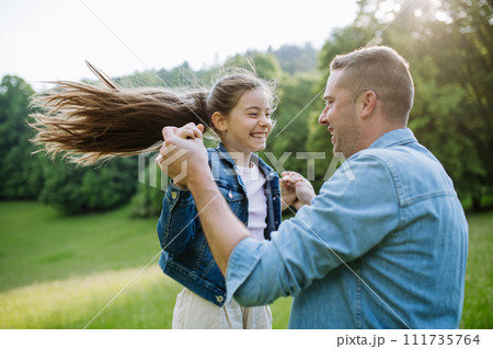 Dad with daughter, playing at meadow, running, having fun. Concept of fathers's Day and fatherly love. Dad with daughter, playing at meadow, running, having fun. Concept of fathers's Day and fatherly love. 111735764