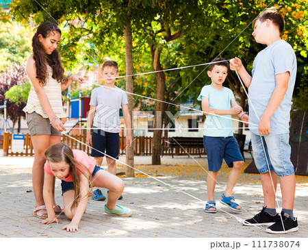 Children games. Girl goes through the tangled rope Children games. Girl goes through the tangled rope 111738074