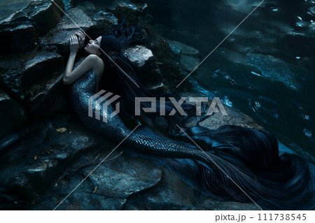 AI-generated content. Mermaid on Rocky Ledge in Shimmering Blue Waters 111738545