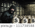 Bank robbery. Criminal in mask with bags of money. Money bags from bank in hands of robber.  111738588
