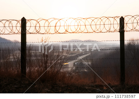 Border of South Kore and North Korea. Border with barbed wire on fence. Border of South Kore and North Korea. Border with barbed wire on fence. 111738597