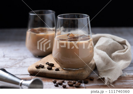 Traditional Irish cream coffee liqueur with ice on wooden table Traditional Irish cream coffee liqueur with ice on wooden table 111740360