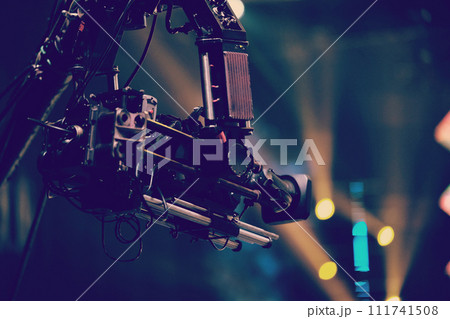 TV camera on a crane at a football match or concert. Close-up live video broadcast camera TV camera on a crane at a football match or concert. Close-up live video broadcast camera 111741508