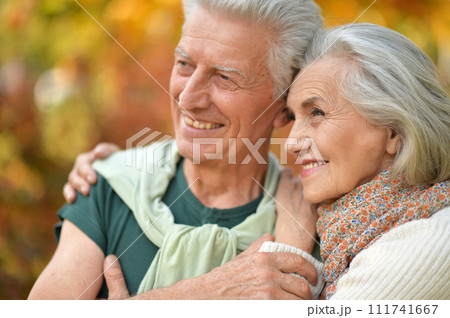 Portrait of happy senior couple in autumn park Portrait of happy senior couple in autumn park 111741667