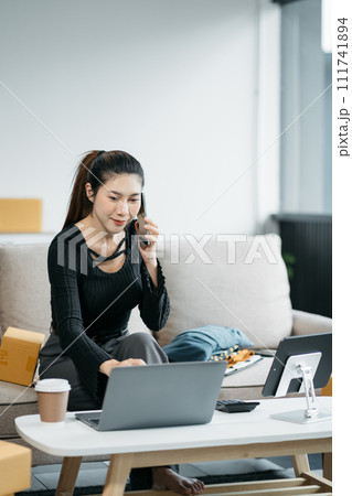 Portrait of a Small Business Startup, SME Owner, Female Entrepreneur work and check orders online. Online SME business idea. 111741894