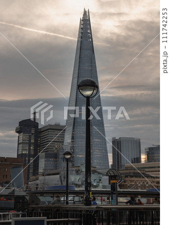 View of The Shard skyscraper, The tallest building with HMS Belfast warship museum on River Thames in front of it. View of The Shard skyscraper, The tallest building with HMS Belfast warship museum on River Thames in front of it. 111742253