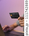 Close-up of hand holding credit card and type on laptop keyboard with online payment for shopping. 111742889