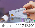 Hands holding credit card to swipe into a card swipe machine to paying for shopping. 111742890