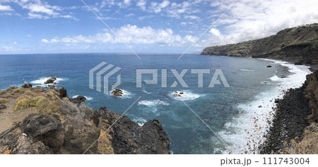 Panoramic coastal landscape rocky cliff, sea waves and blue sky with clouds 111743004