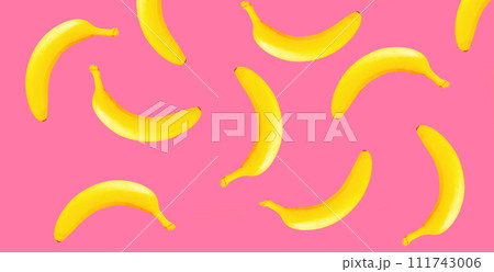 Stylish creative image yellow banana on pink background Stylish creative image yellow banana on pink background 111743006