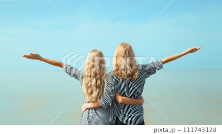 Two women together, happy girlfriends or mother with adult daughter on sea Two women together, happy girlfriends or mother with adult daughter on sea 111743128