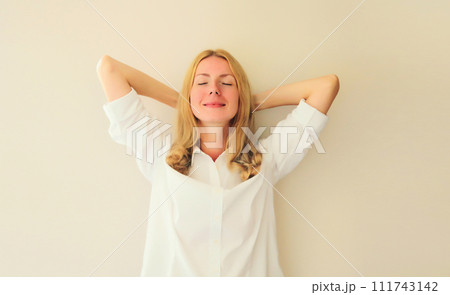 Relaxed happy young woman take a break meditates with closed eyes while working 111743142