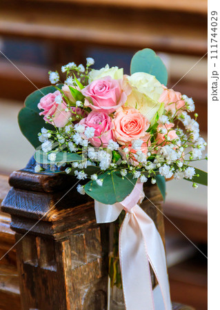 Close-up of a beautiful flower wedding decoration in church Close-up of a beautiful flower wedding decoration in church 111744029