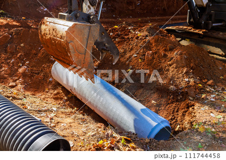 Installation of pipes at construction site that allow rainwater to flow into water main collector 111744458