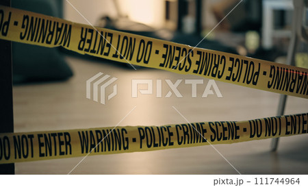 A close-up of warning tape at the crime scene, evidence preservation in the police investigation 111744964