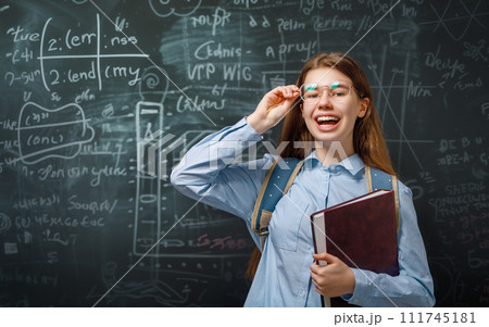 Teenager in class on background of blackboard Teenager in class on background of blackboard 111745181