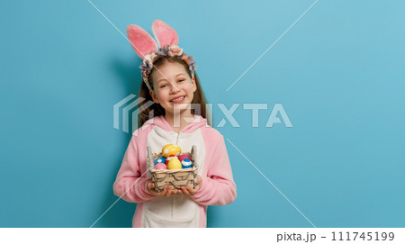 Girl with painted eggs. 111745199