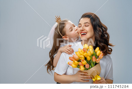 Daughter and mother with bouquet of flowers 111745284