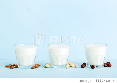 Set or collection of various vegan milk almond, cashew, on table background. Vegan plant based milk and ingredients, top view 111746017