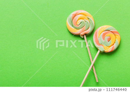 Set of colorful lollipops on colored background. Summer concept. Party Happy Birthday or Minimalist Concept Set of colorful lollipops on colored background. Summer concept. Party Happy Birthday or Minimalist Concept 111746440