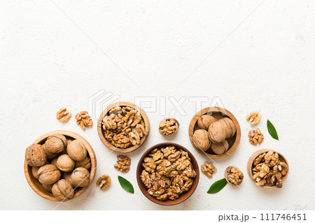 Walnut kernel halves, in a wooden bowl. Close-up, from above on colored background. Healthy eating Walnut concept. Super foods with copy space 111746451