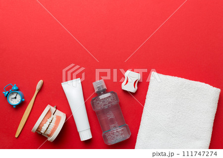 Mouthwash and other oral hygiene products on colored table top view with copy space. Flat lay. Dental hygiene. Oral care kit. Dentist concept 111747274