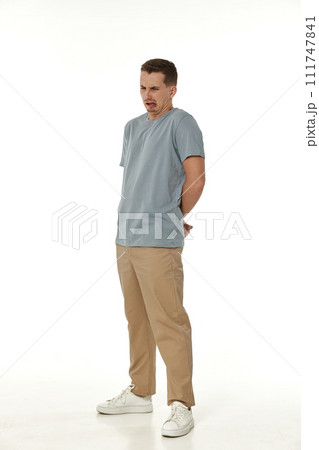 young man shows her toung, feels disgust on white background. young man shows her toung, feels disgust on white background. 111747841