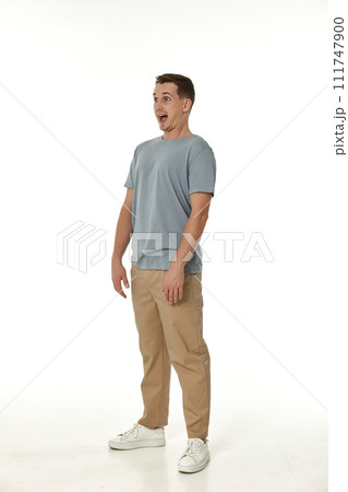 surprised guy looking at camera on white studio background 111747900